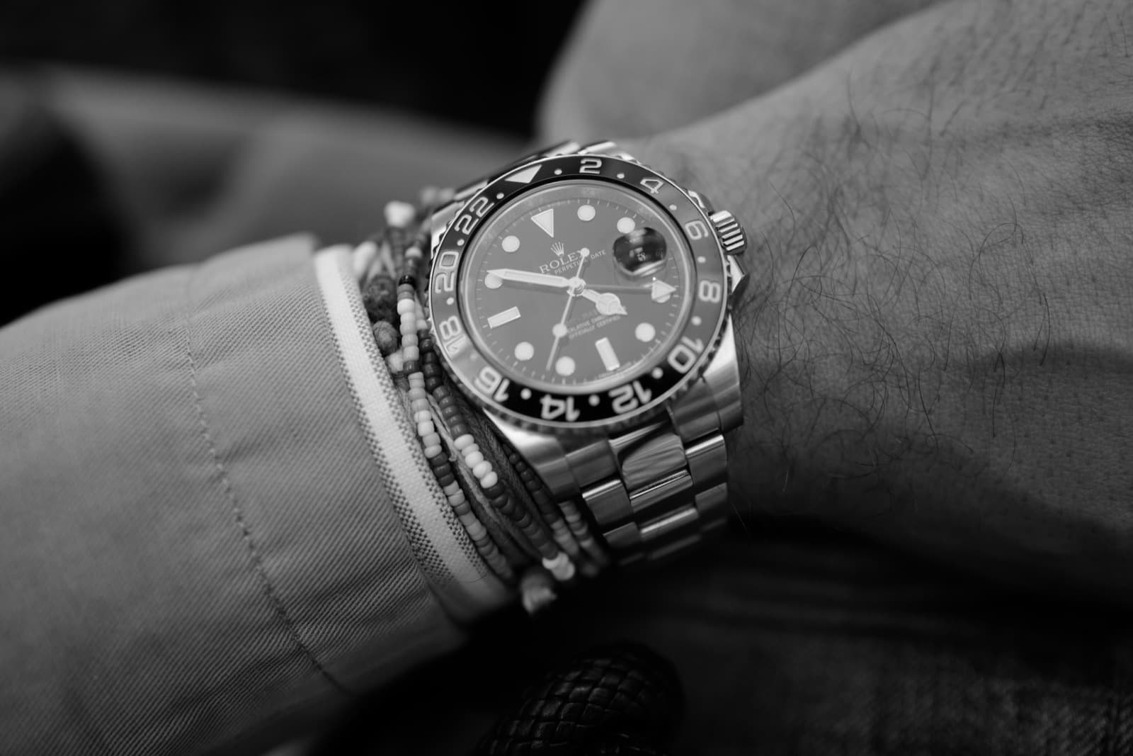 A scratched steel Rolex GMT-Master II worn on its owner's wrist.
